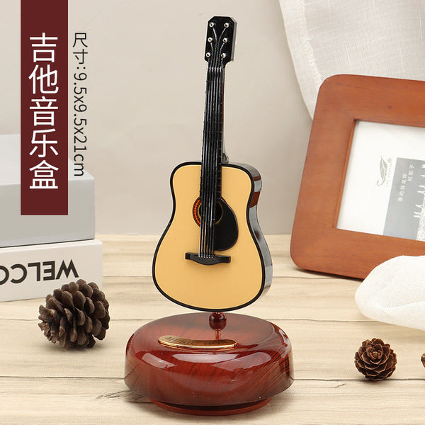 Miniature guitar music box with rotating wind-up base, 21 cm